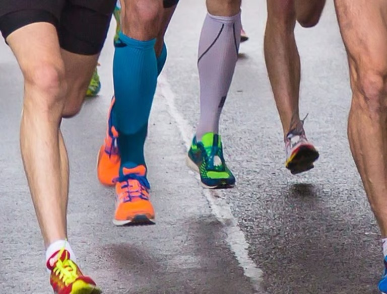 A group of runners moving together during a road race