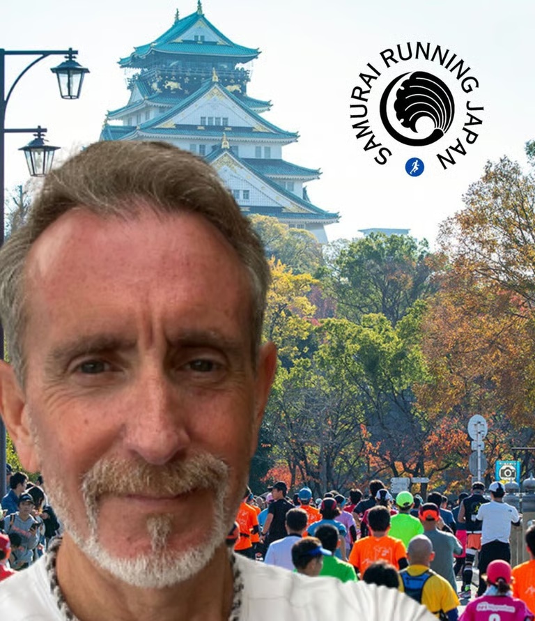 Scott Andrew Brown with Osaka Castle and marathon runners behind him